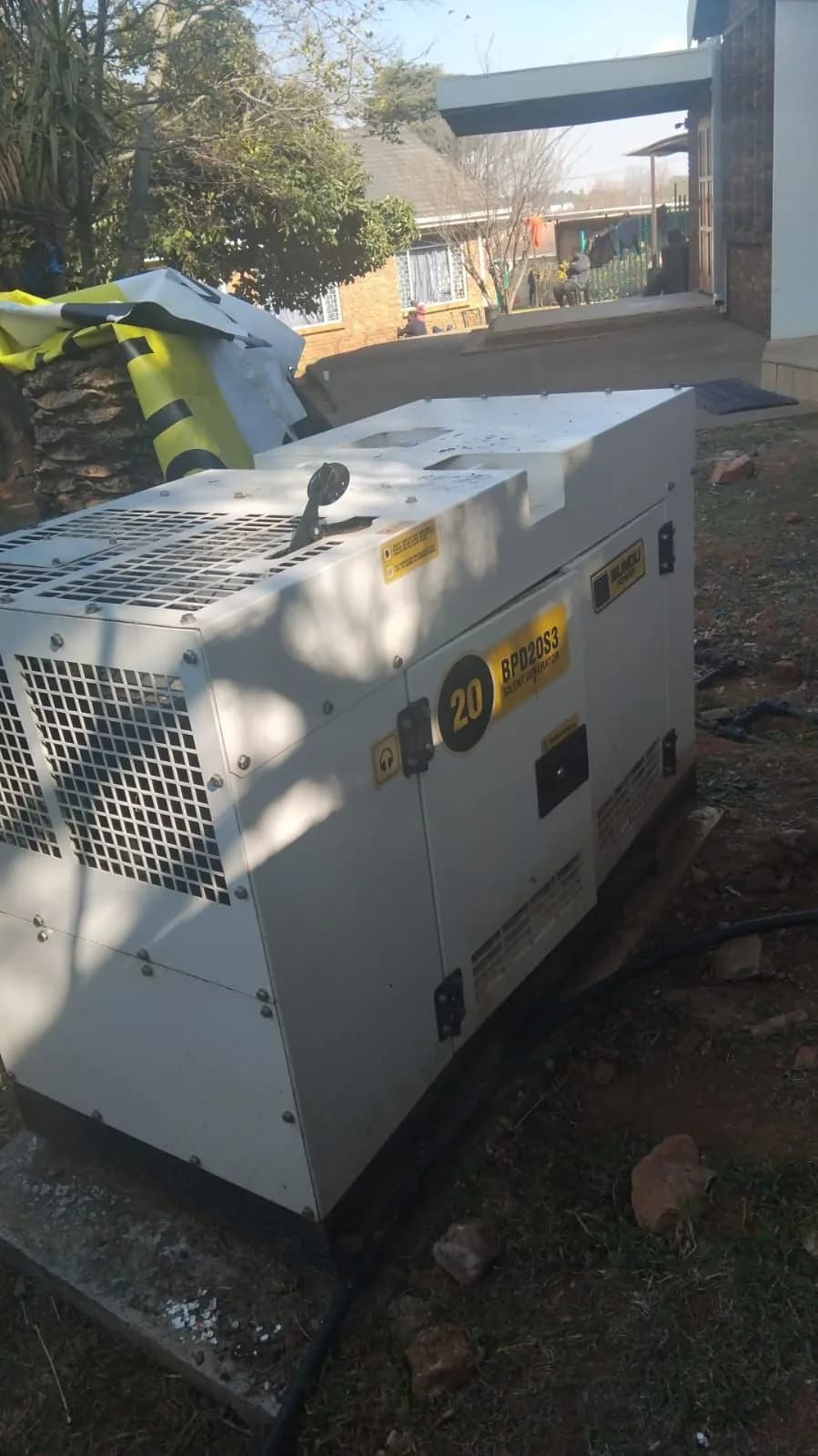 Compact standby generator installed at a house