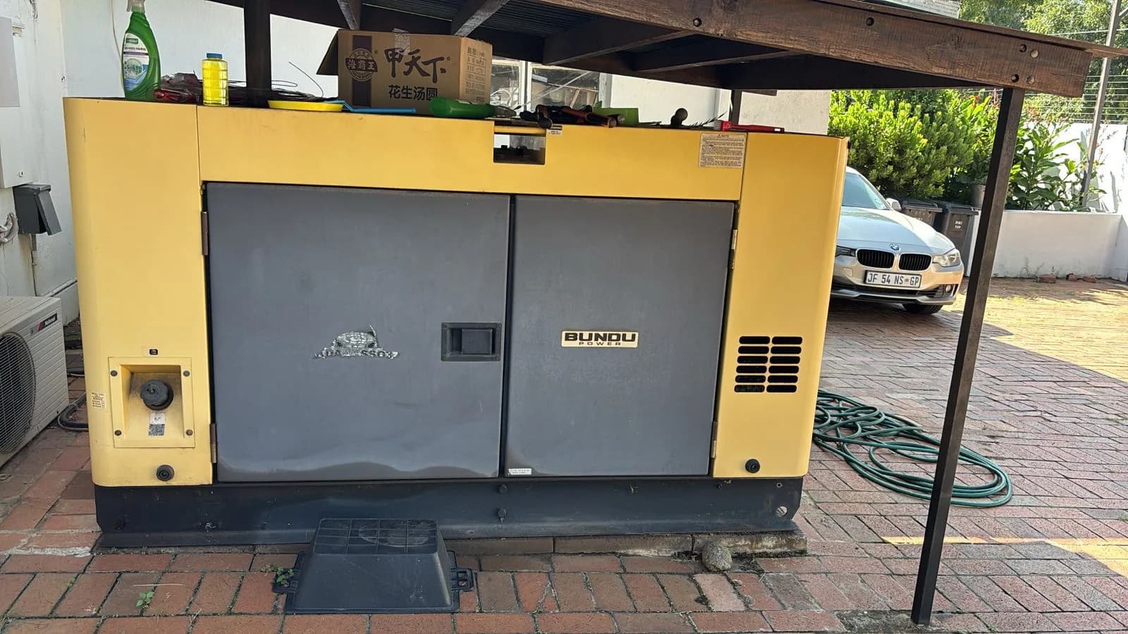 Technicians installing a standby generator at a commercial building