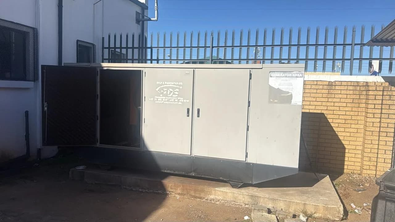 Two technicians inspecting a residential standby generator