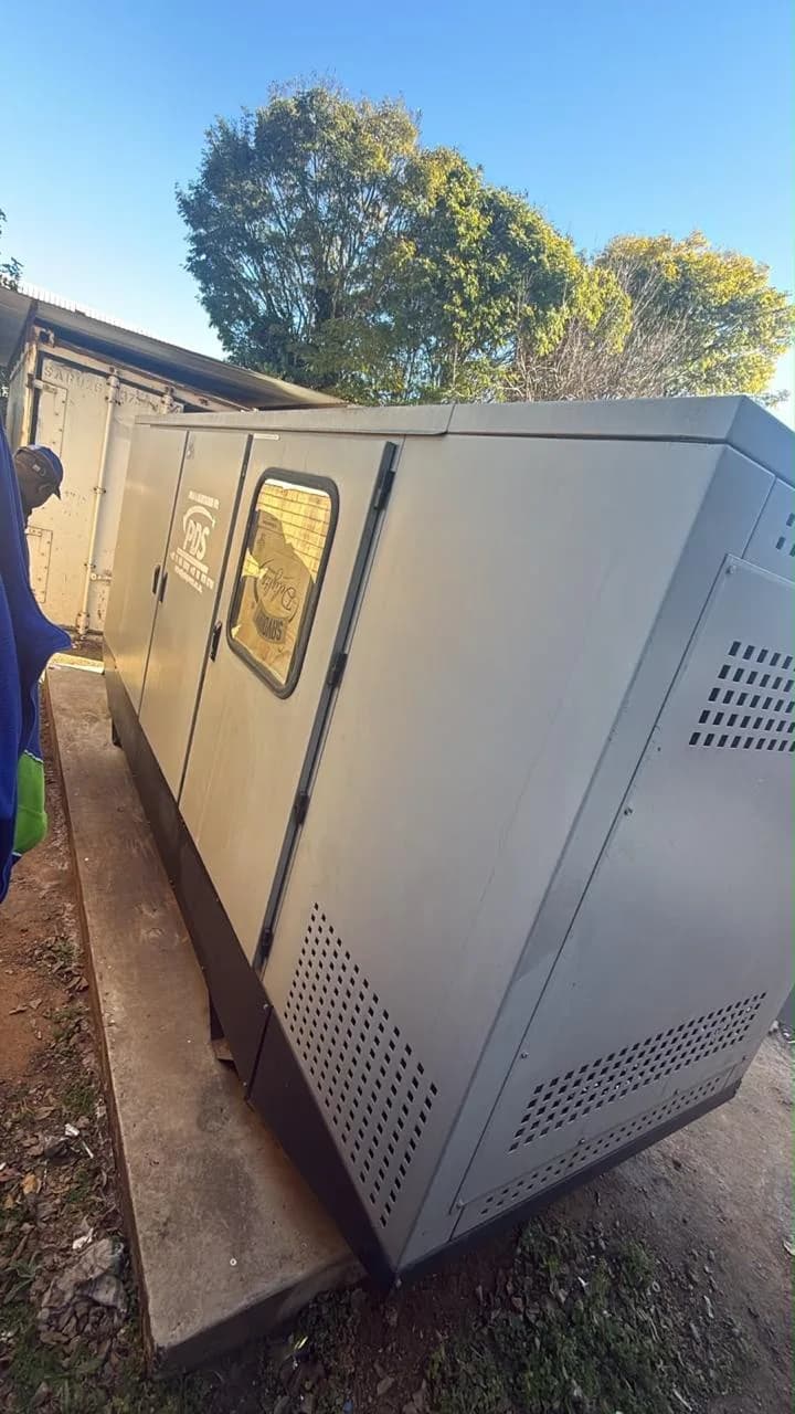 Two technicians diagnosing a business generator