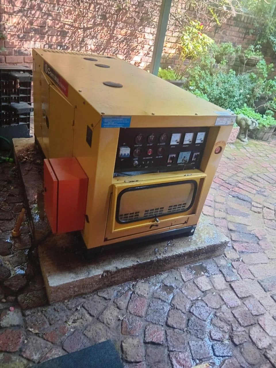 Two technicians working on a commercial generator