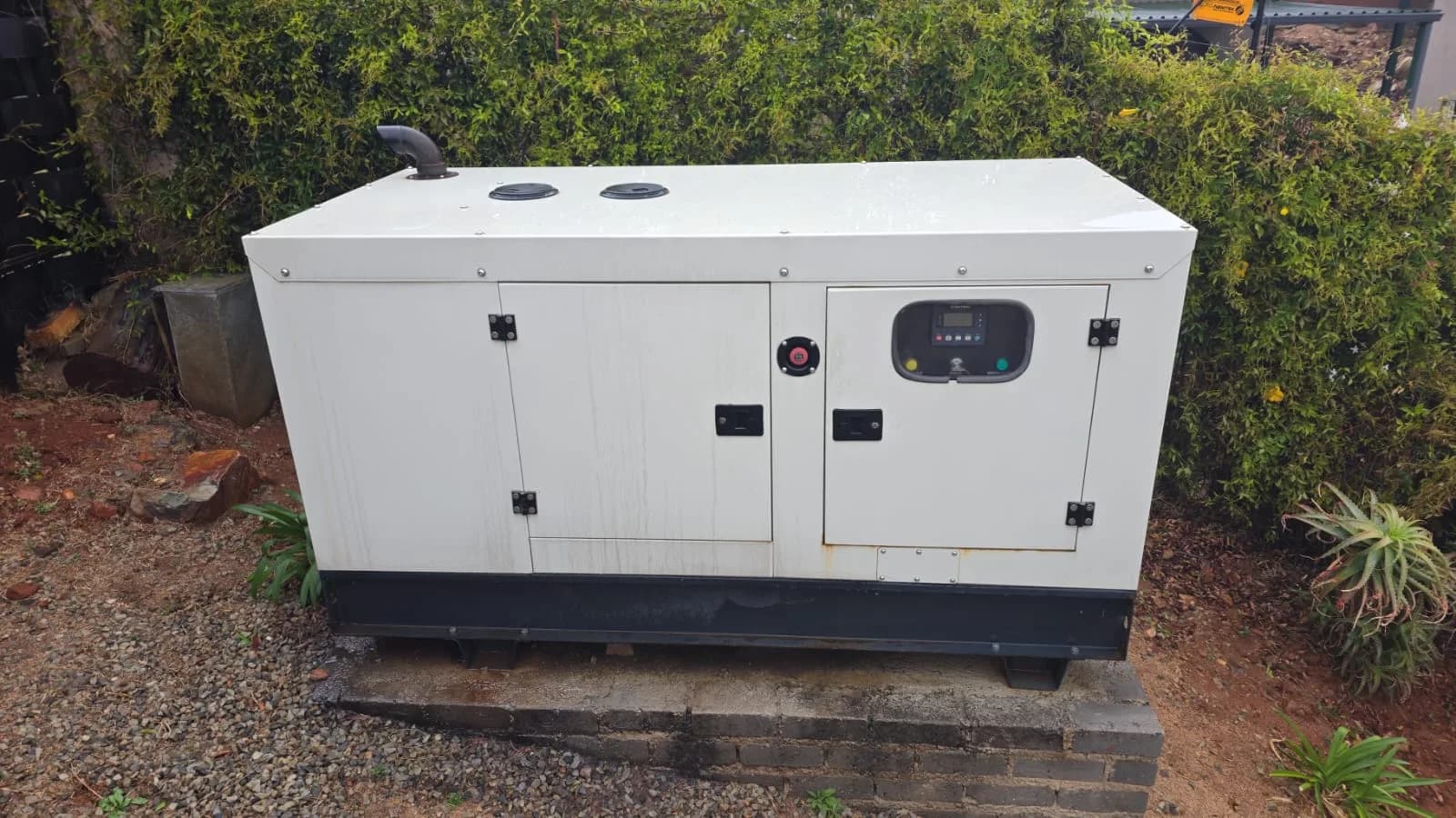 Large three-phase diesel generator installed at a warehouse