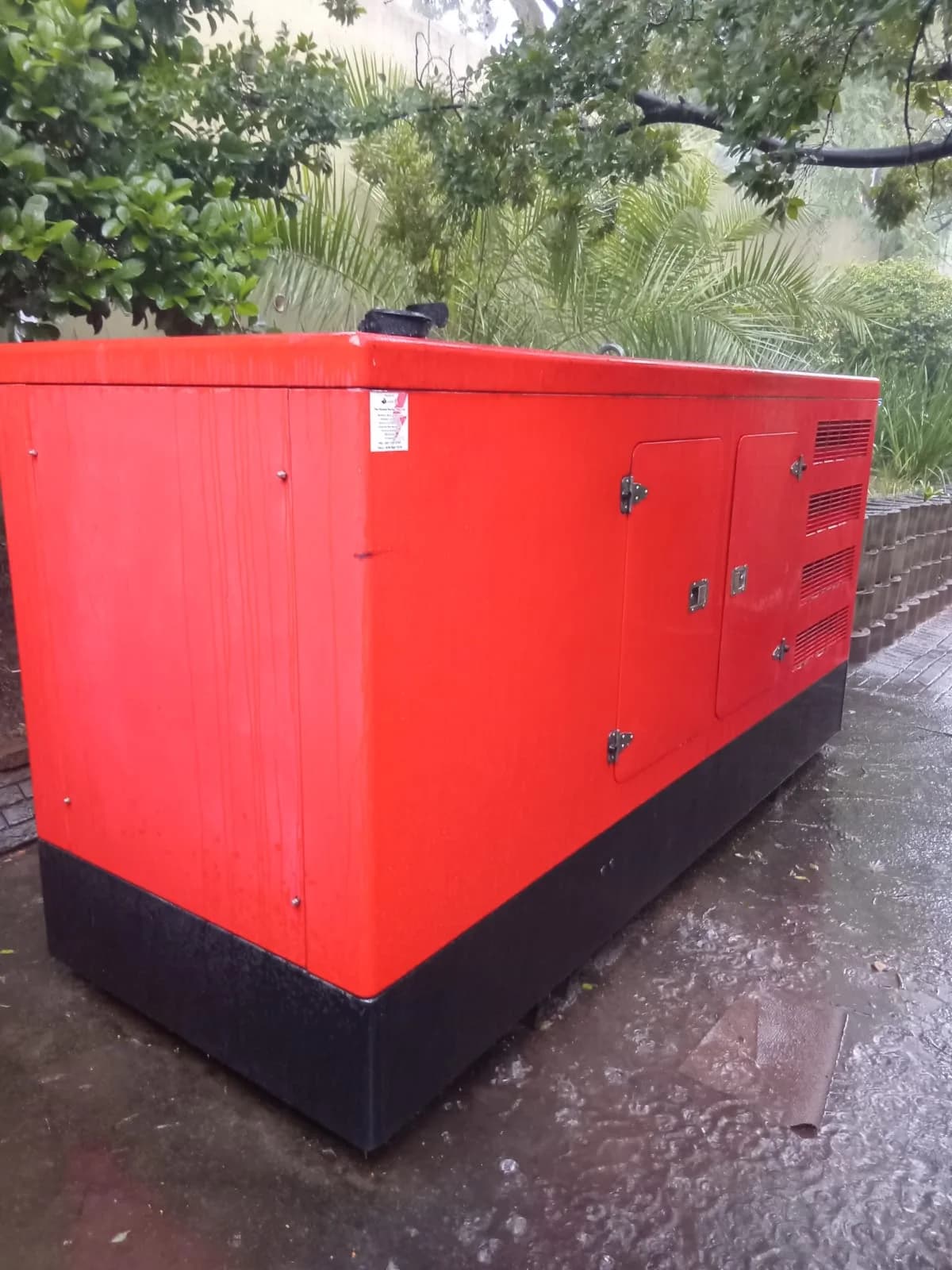 Technicians testing a diesel generator connected to a load bank