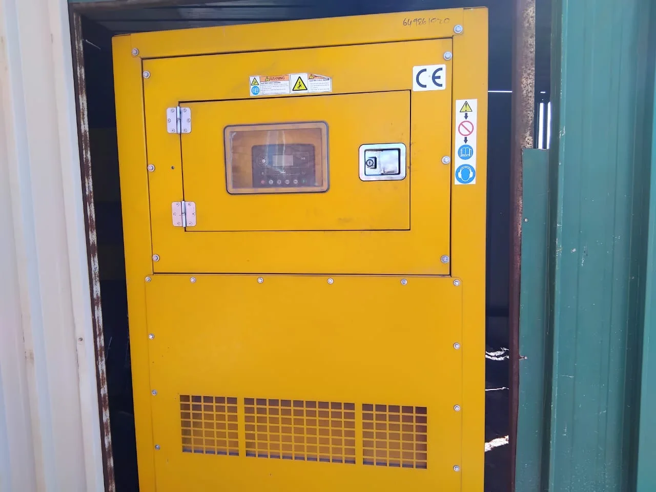 Two technicians working on a commercial generator