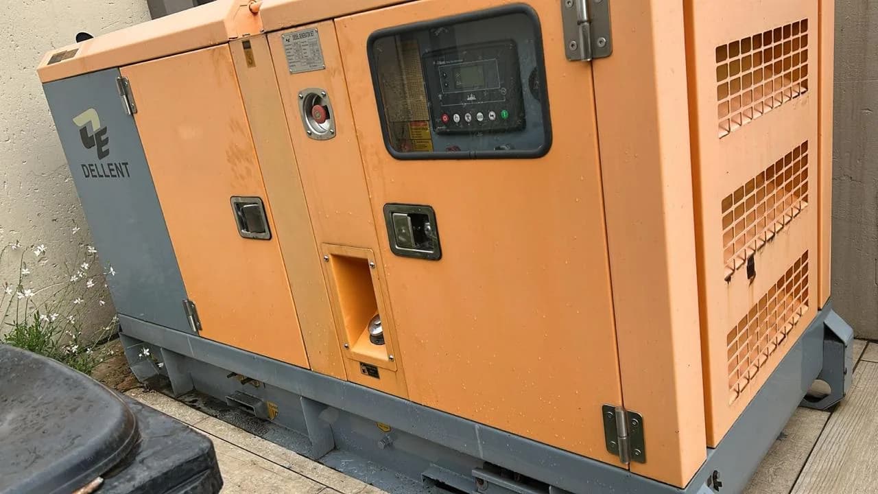 Two technicians working on a commercial generator