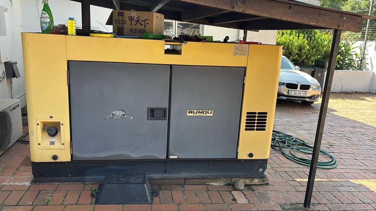 Two technicians inspecting a commercial generator