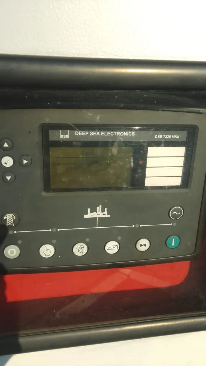 Technicians diagnosing a generator controller module