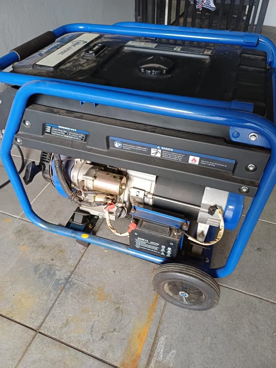 Two technicians inspecting a residential standby generator