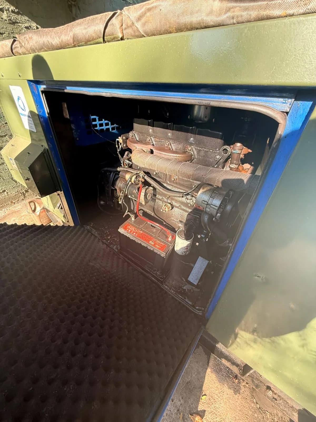 Two technicians servicing an estate standby generator