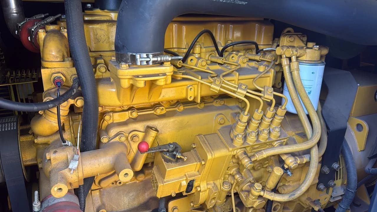 Technicians inspecting a coolant hose leak on a generator radiator