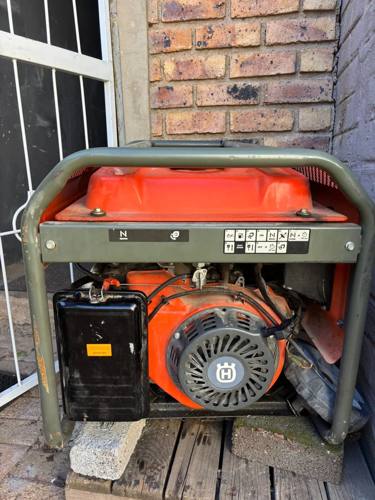 Two technicians inspecting a generator radiator during an overheating diagnosis