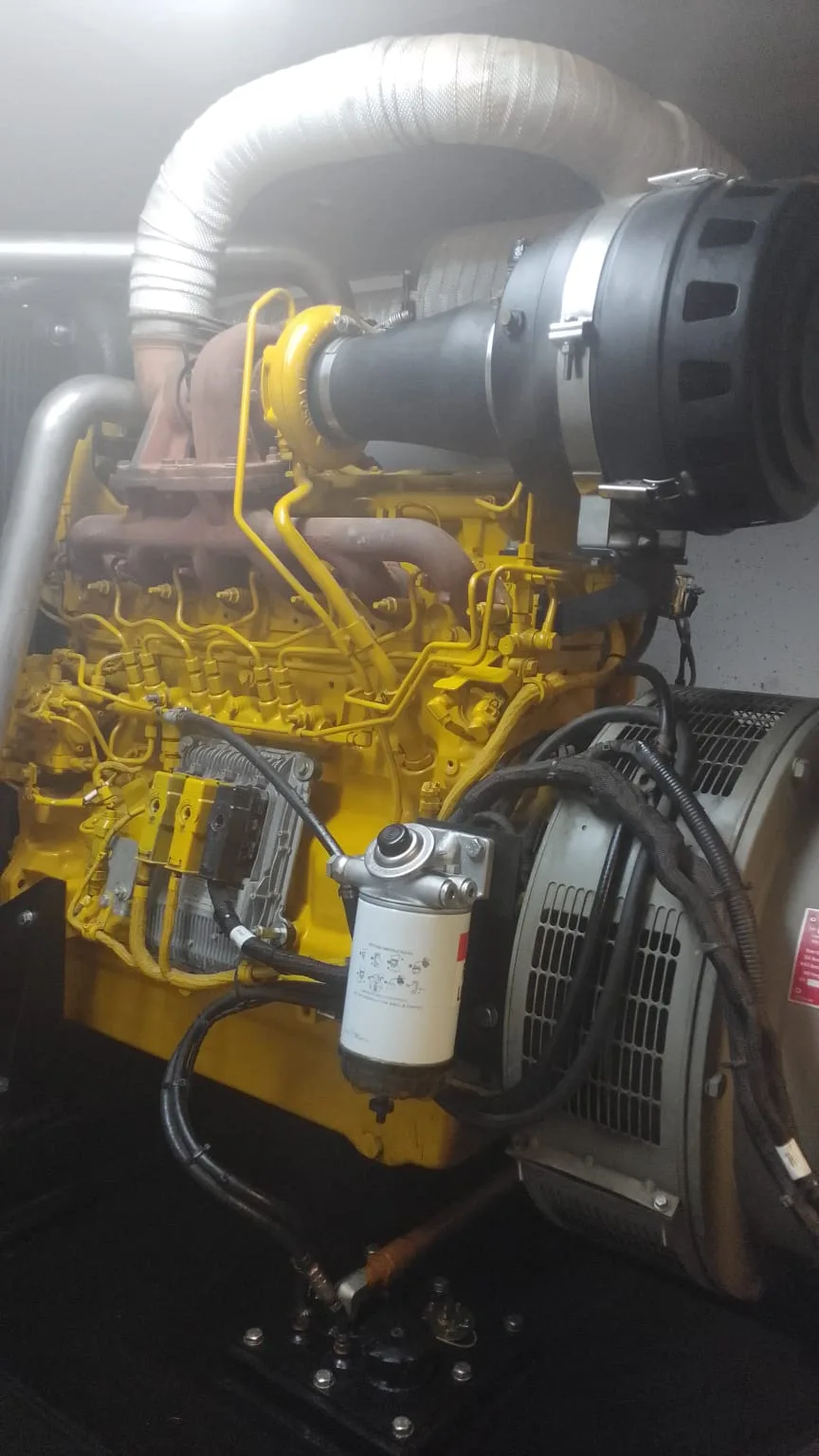 Two technicians checking fuel delivery on a diesel generator that cranks but will not start