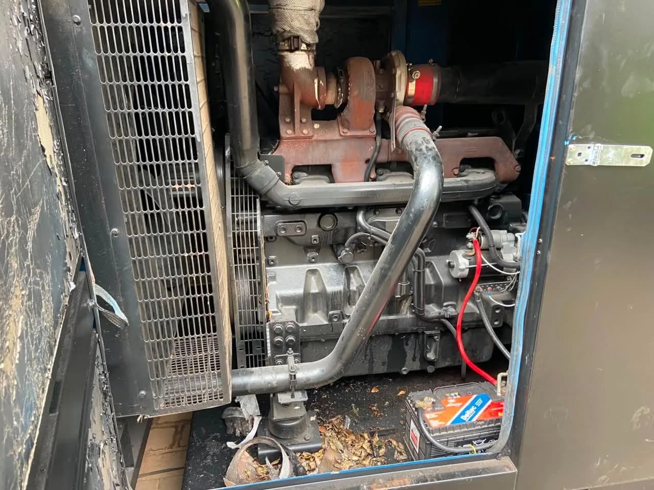 Two technicians servicing a home generator