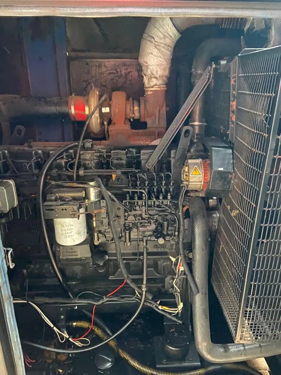Two technicians repairing a commercial generator