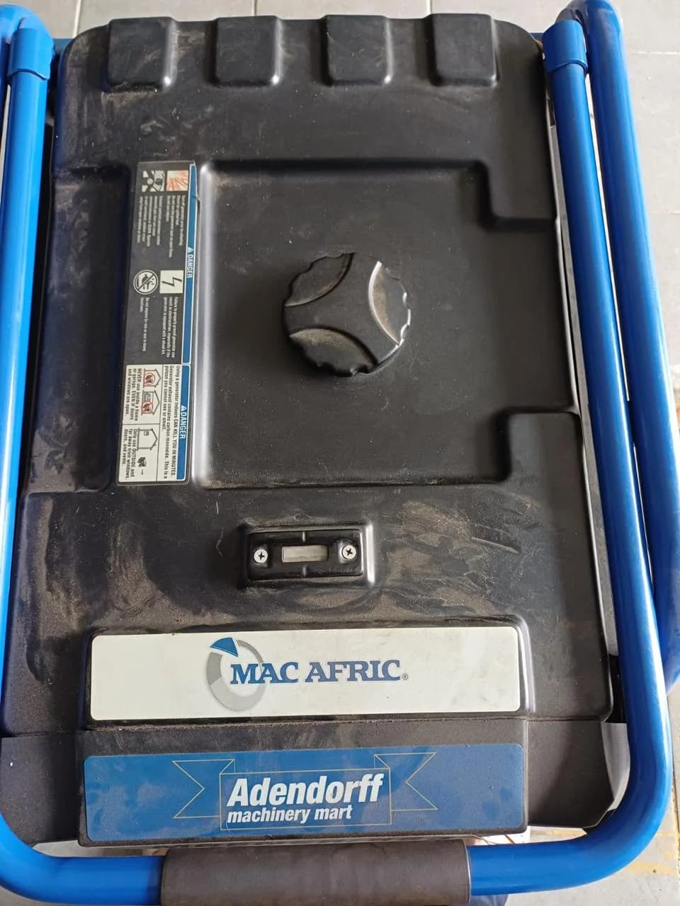 Mac Afric portable petrol generator being inspected