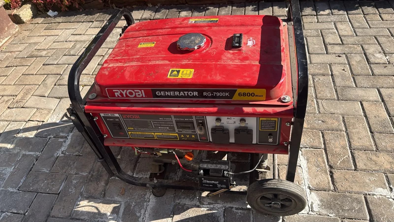 Two technicians inspecting portable petrol generators