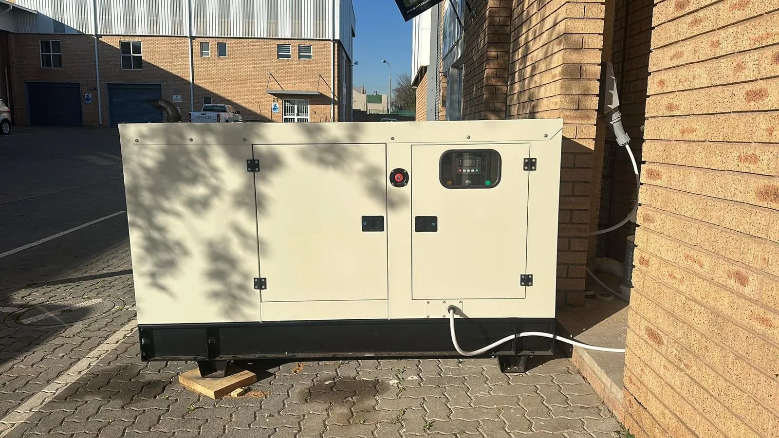 Silent canopy standby generator on a concrete base